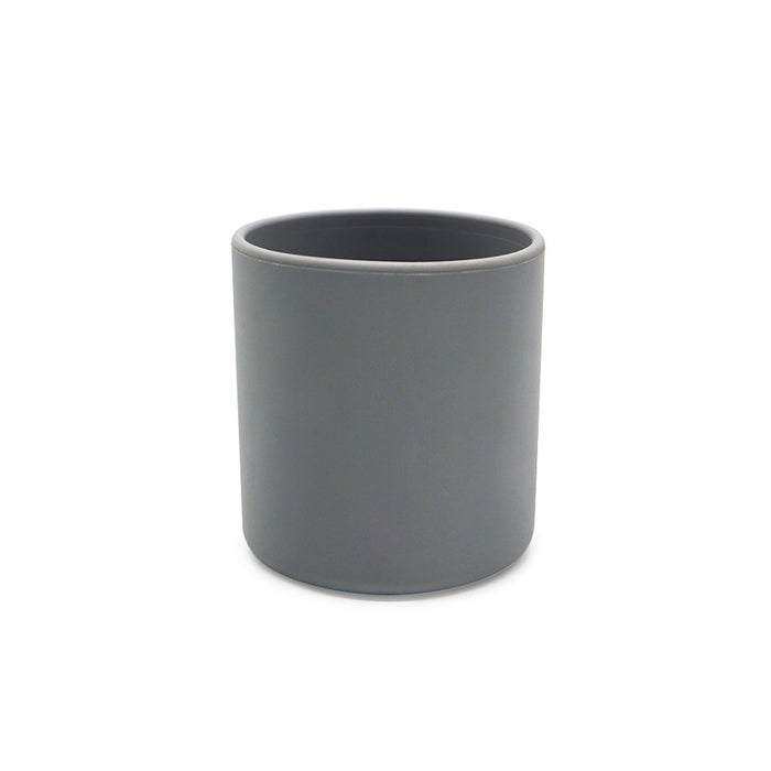 En vanlig, cylindrisk mörkgrå keramisk mugg med matt finish, placerad mot en vit bakgrund. TOS Silikon Klassisk Mugg från Toddlers Of Sweden har en enkel, minimalistisk design utan några handtag eller utsmyckningar.